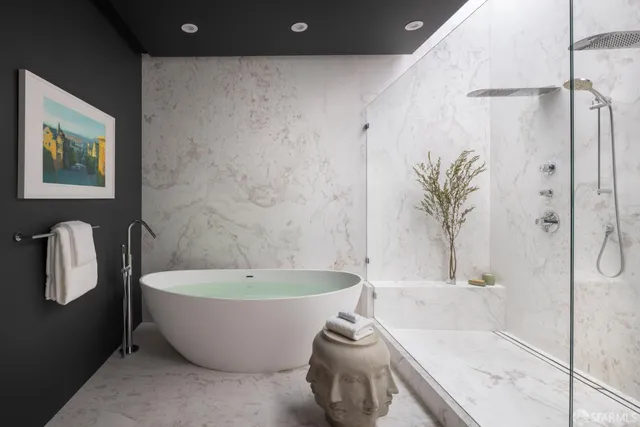 a white bath tub sitting next to a white toilet