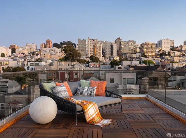 a view of a roof deck with furniture