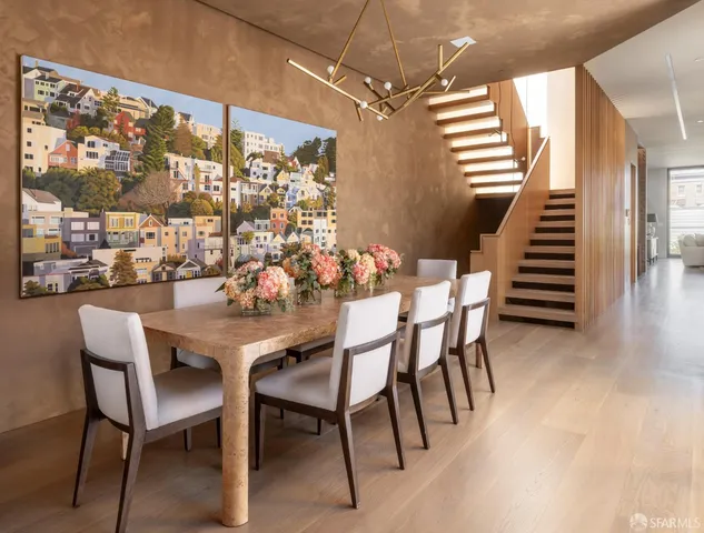 a dining room with furniture and wooden floor