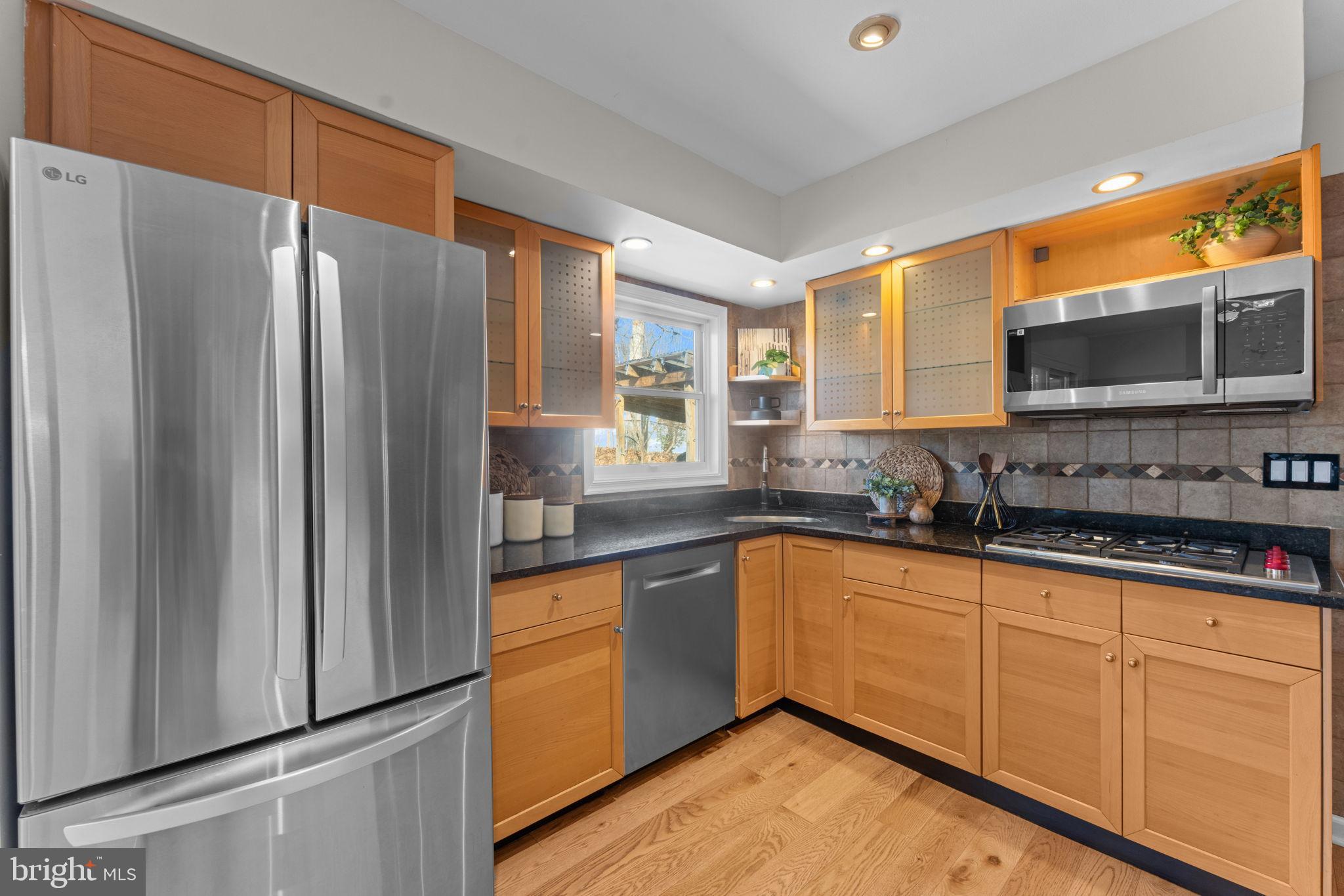 7448 Long Pine Drive Springfield, VA 22151 - Photo 11 of 40 a kitchen with stainless steel appliances granite countertop a refrigerator and a sink