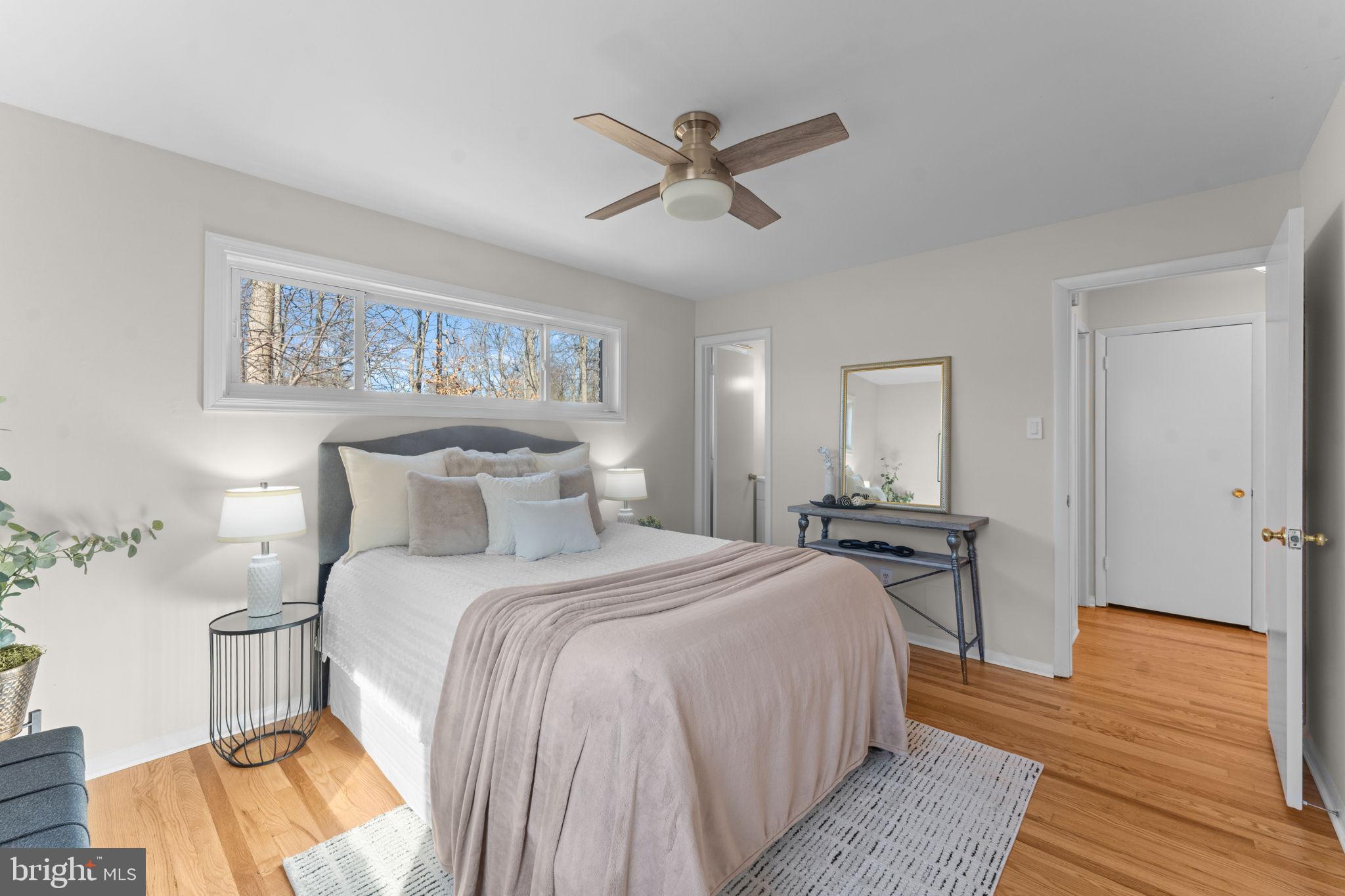 7448 Long Pine Drive Springfield, VA 22151 - Photo 15 of 40 a bedroom with a bed and wooden floor