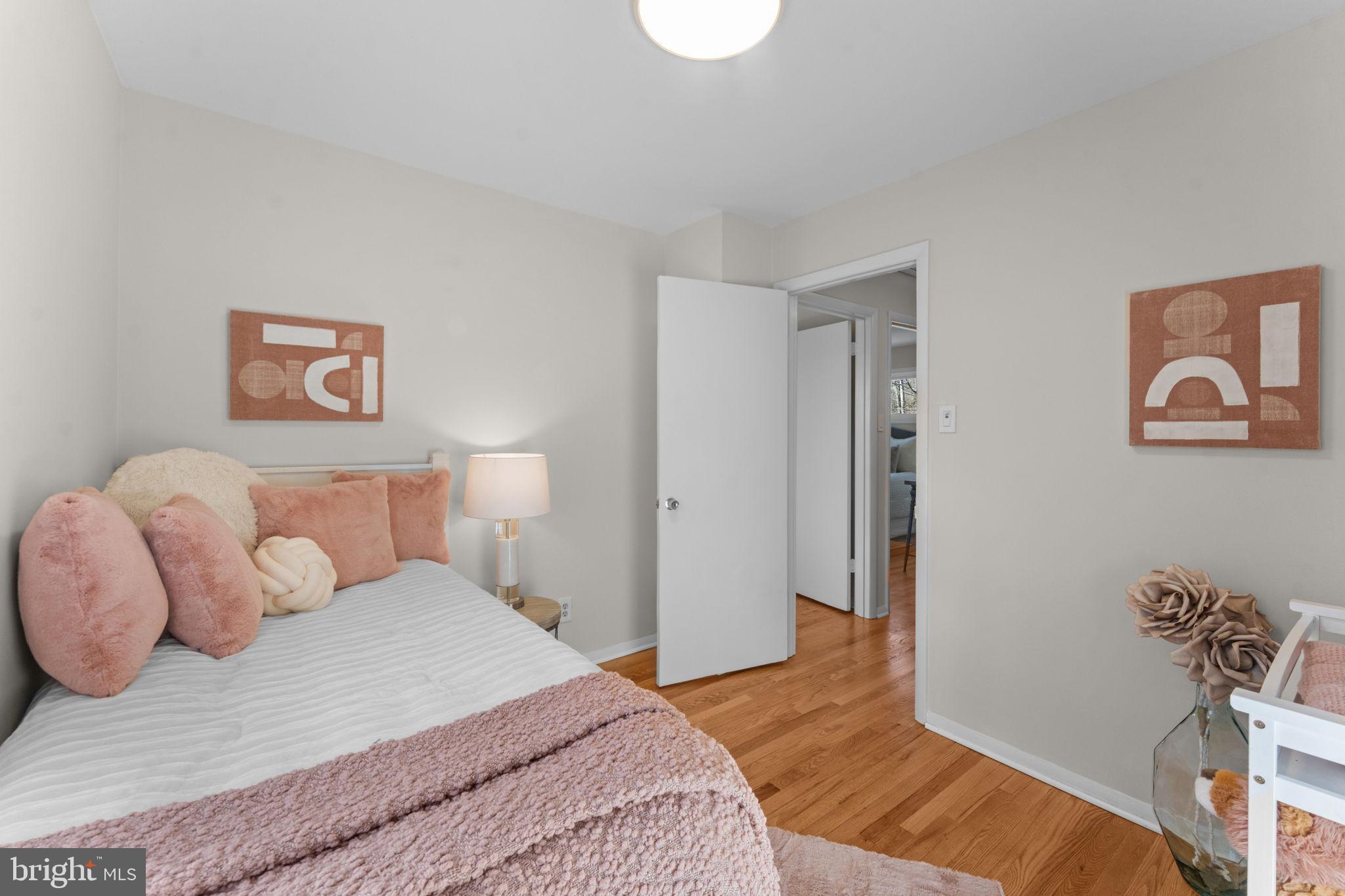 7448 Long Pine Drive Springfield, VA 22151 - Photo 20 of 40 a bedroom with a bed and painting on the wall