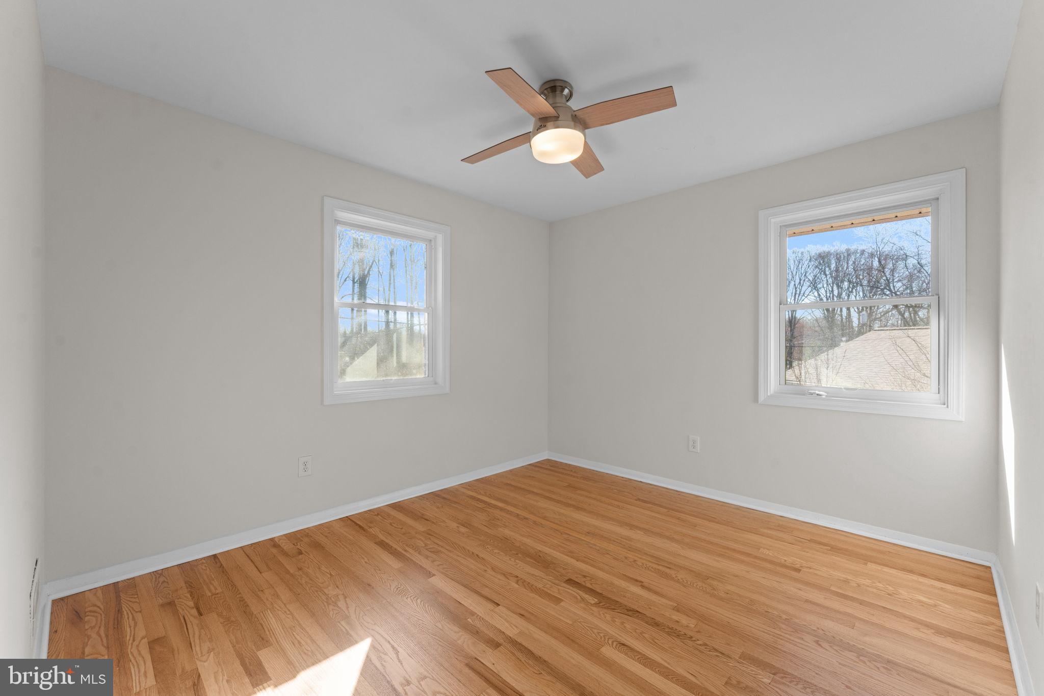 7448 Long Pine Drive Springfield, VA 22151 - Photo 21 of 40 a view of a big room with wooden floor and a ceiling fan