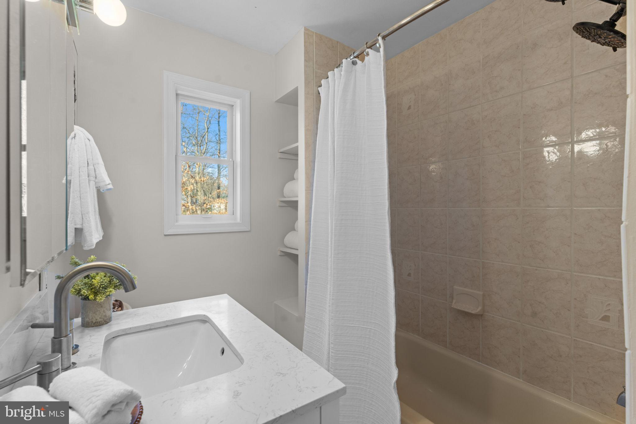7448 Long Pine Drive Springfield, VA 22151 - Photo 23 of 40 a bathroom with a sink and a bathtub