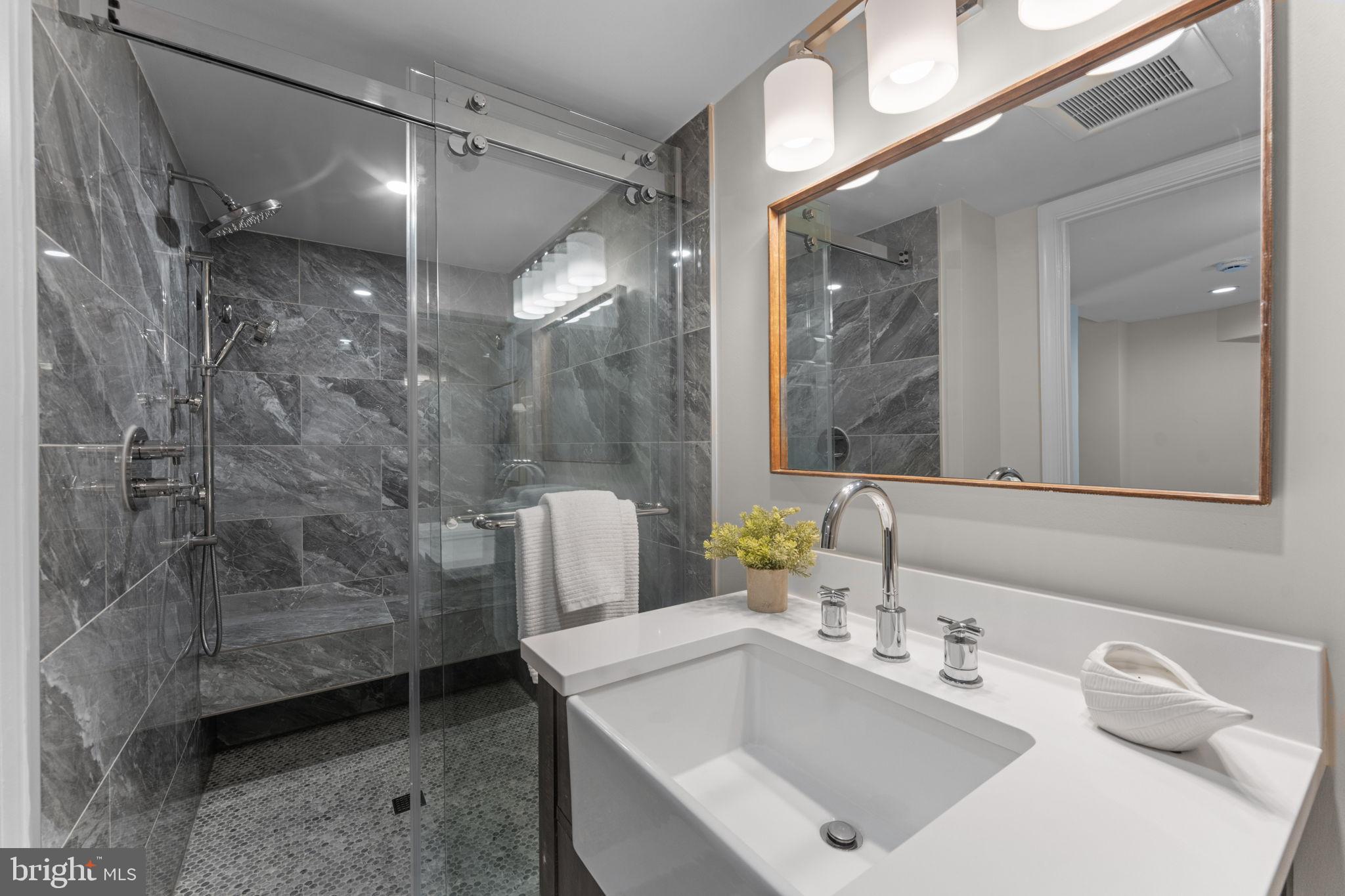 7448 Long Pine Drive Springfield, VA 22151 - Photo 34 of 40 a bathroom with a sink mirror and shower