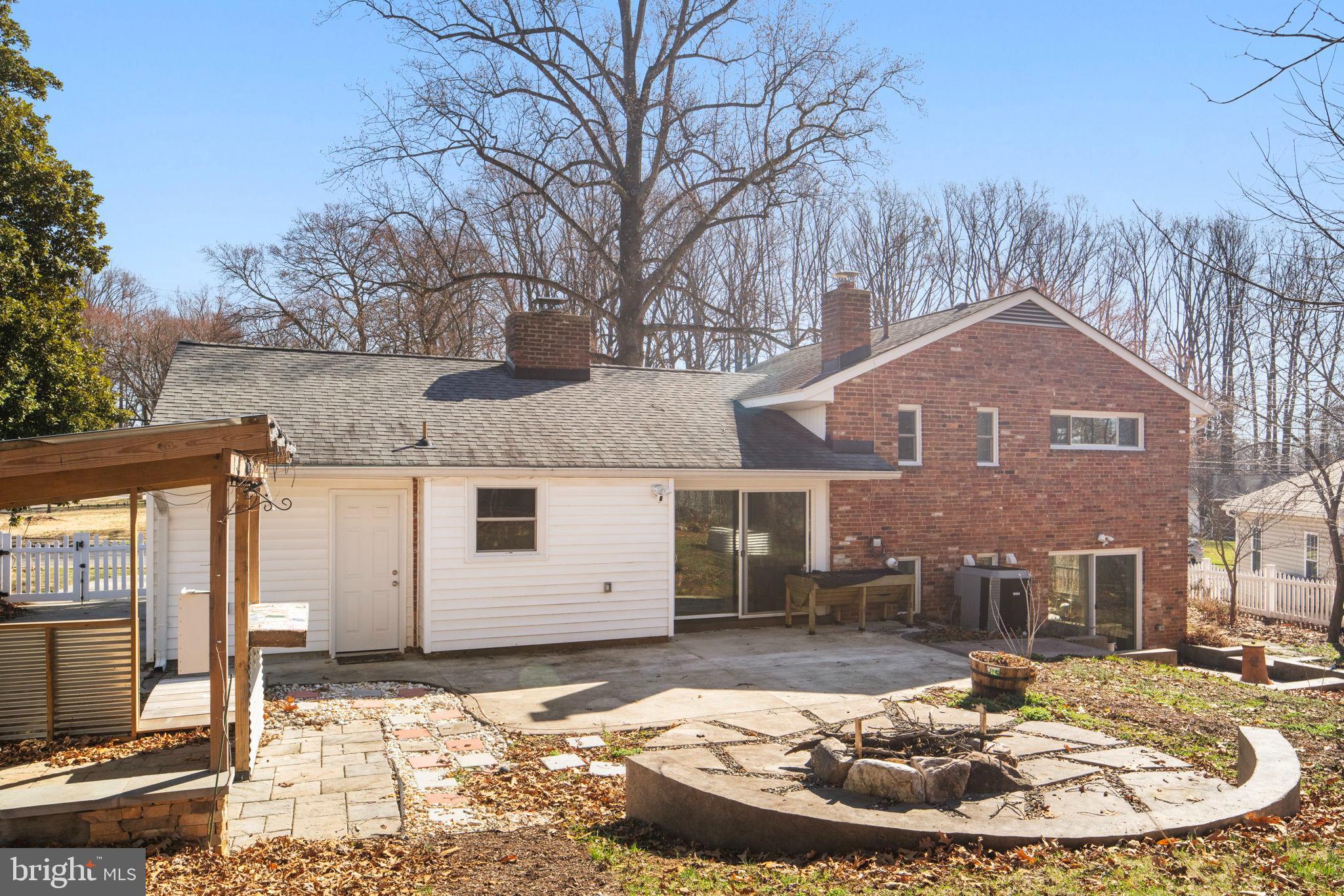 7448 Long Pine Drive Springfield, VA 22151 - Photo 36 of 40 a view of a white house with a small yard and large tree