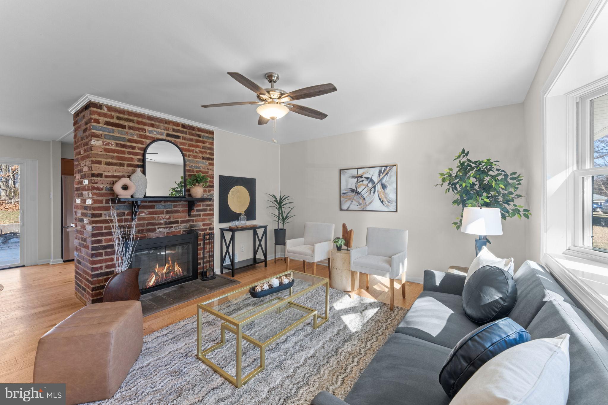 7448 Long Pine Drive Springfield, VA 22151 - Photo 6 of 40 a living room with furniture a fireplace and a large window