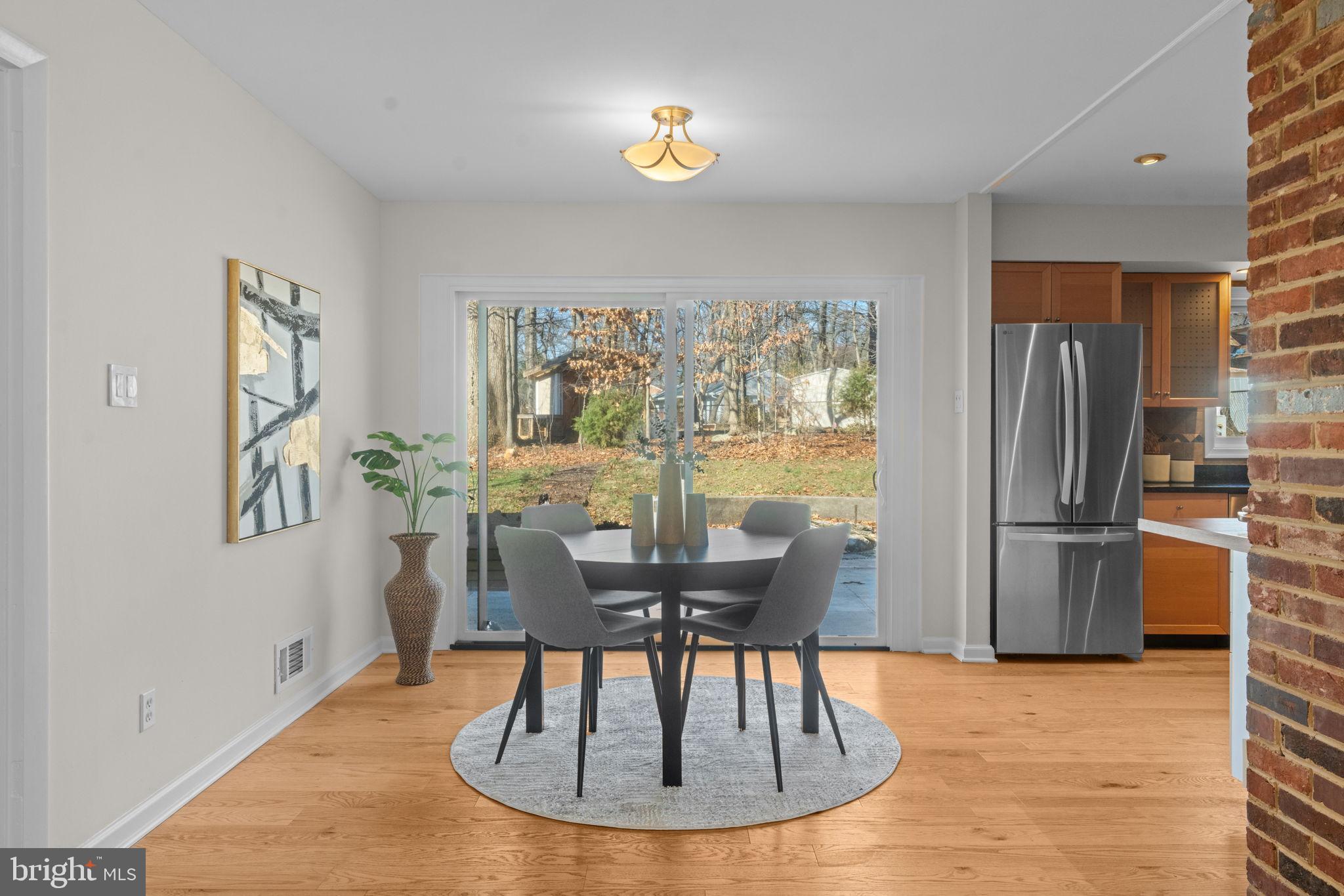 7448 Long Pine Drive Springfield, VA 22151 - Photo 8 of 40 a dining room with furniture a chandelier and wooden floor