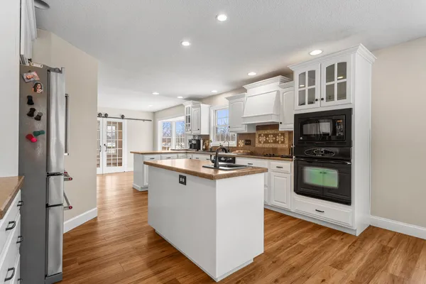 a kitchen with stainless steel appliances granite countertop a stove and a refrigerator