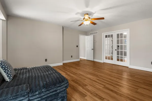 a bedroom with a bed and a chandelier