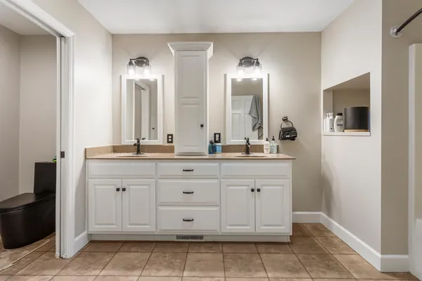 a bathroom with a double vanity sink and a mirror