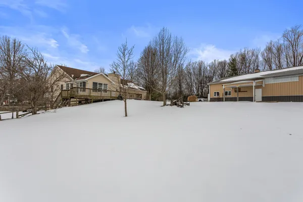 a view of a house with a snow in the yard