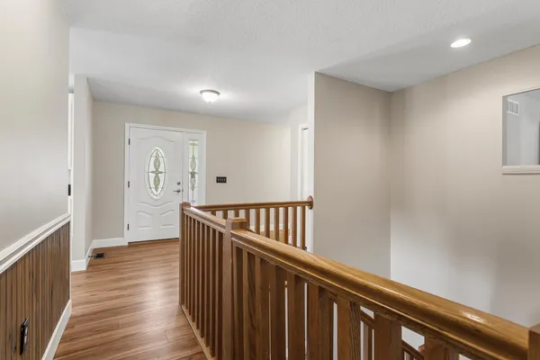 a view of hallway with wooden floor