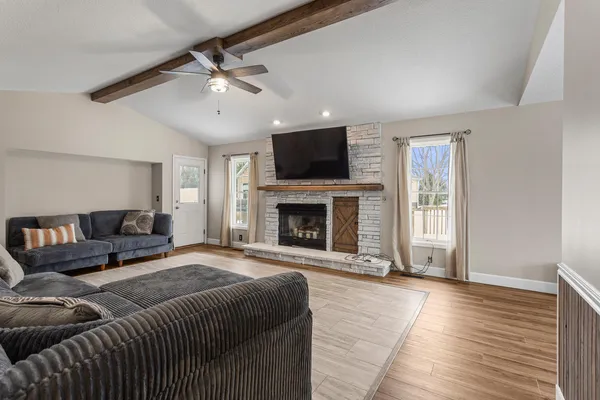 a spacious bedroom with a large bed and a fireplace