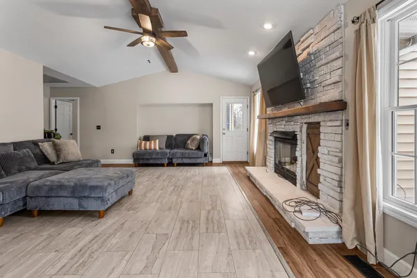 a living room with furniture and a fireplace