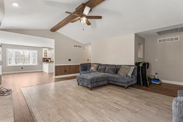 a living room with furniture and wooden floor