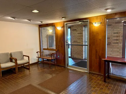 a lobby with furniture and a rug