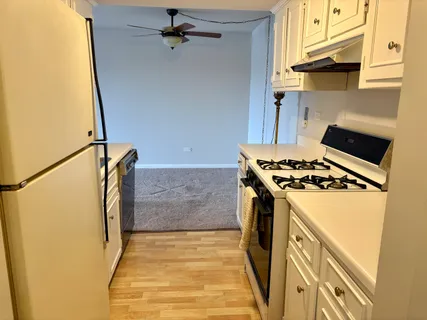 a kitchen with a stove and a refrigerator