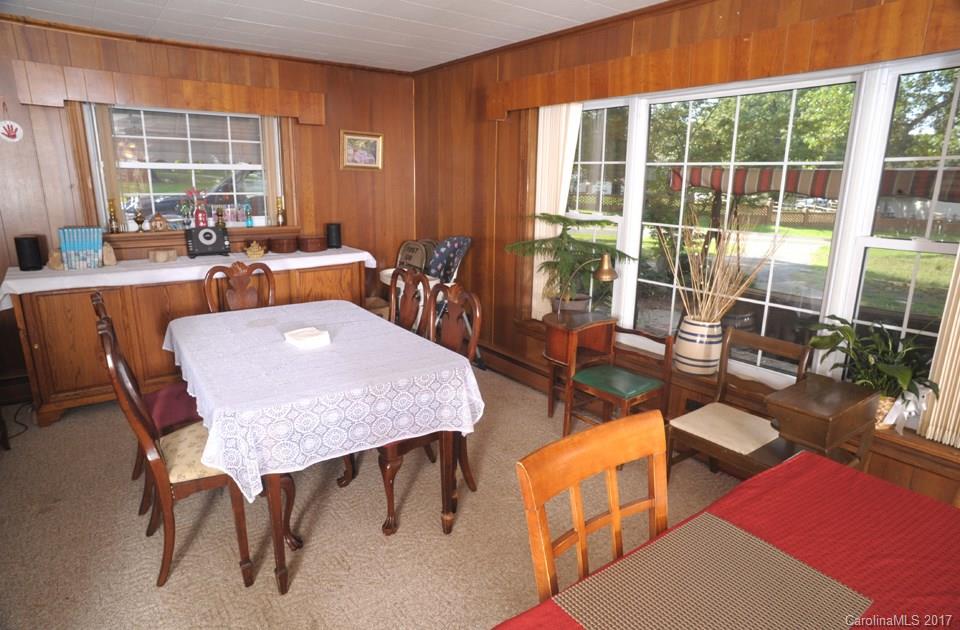 7135 Pop Basinger Road Salisbury, NC 28146 - Photo 13 of 23 a dining room with furniture a rug and a large window