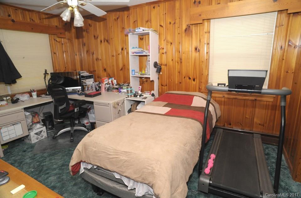 7135 Pop Basinger Road Salisbury, NC 28146 - Photo 17 of 23 a bedroom with a bed a desk and chair