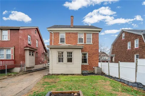 a view of a brick house with a large window