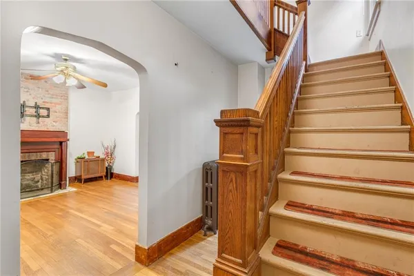 a view of entryway and hall with wooden floor