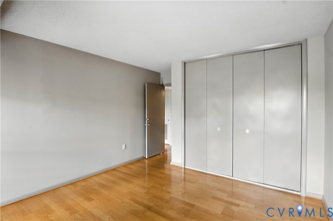 2956 Hathaway Road, Unit U102 Richmond, VA 23225 - Photo 17 of 37 Unfurnished bedroom featuring light wood-style flo