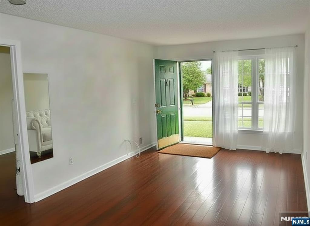 727 Pepperidge Road Mahwah, NJ 07430 - Photo 2 of 10 a view of an empty room with wooden floor and a window
