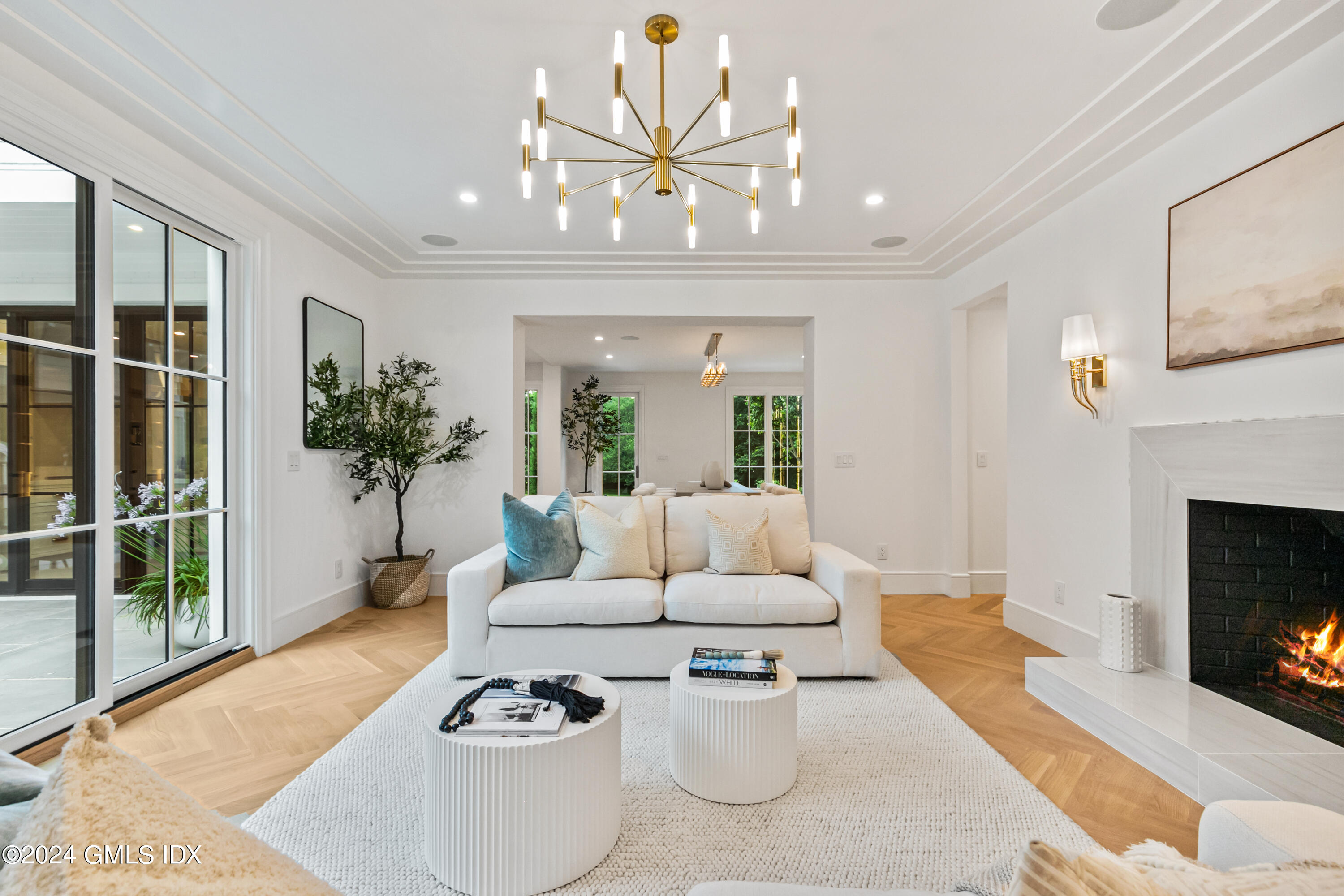 248 Round Hill Road Greenwich, CT 06831 - Photo 14 of 49 a living room with furniture a chandelier and a fireplace