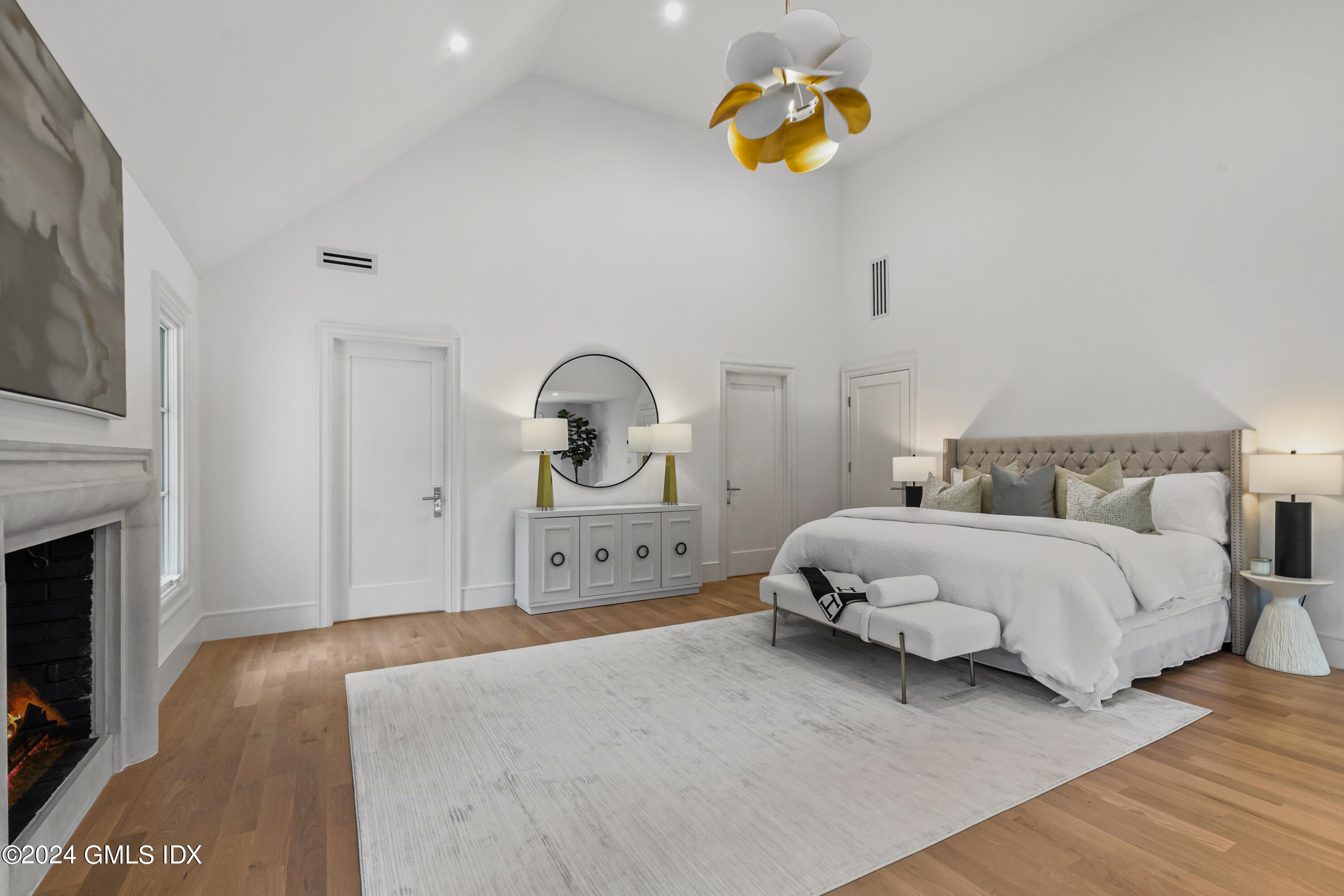 248 Round Hill Road Greenwich, CT 06831 - Photo 19 of 49 a bedroom with a bed and a chandelier