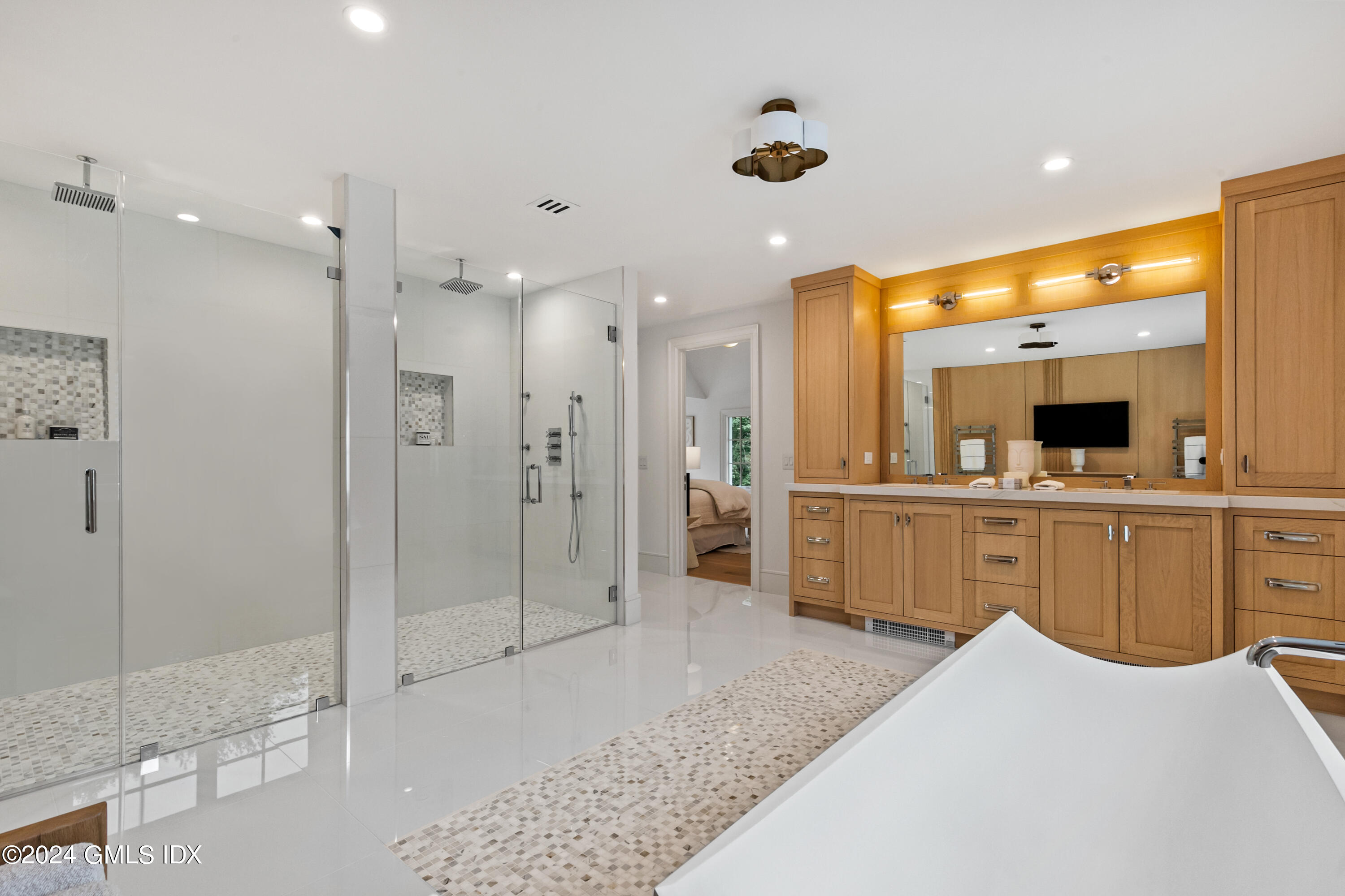 248 Round Hill Road Greenwich, CT 06831 - Photo 22 of 49 a large bathroom with a glass door shower a sink and a mirror