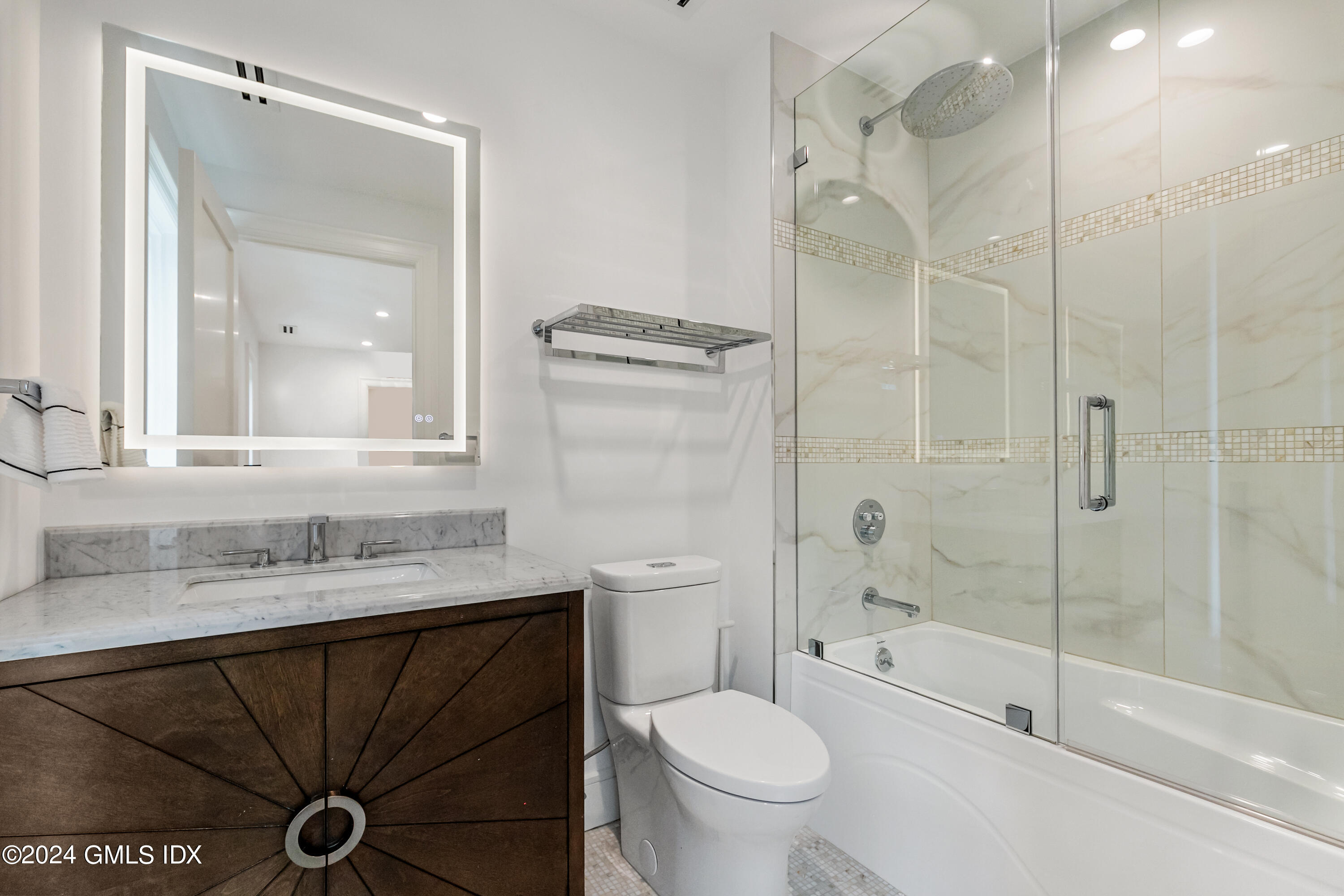 248 Round Hill Road Greenwich, CT 06831 - Photo 32 of 49 a bathroom with a granite countertop sink toilet mirror and shower