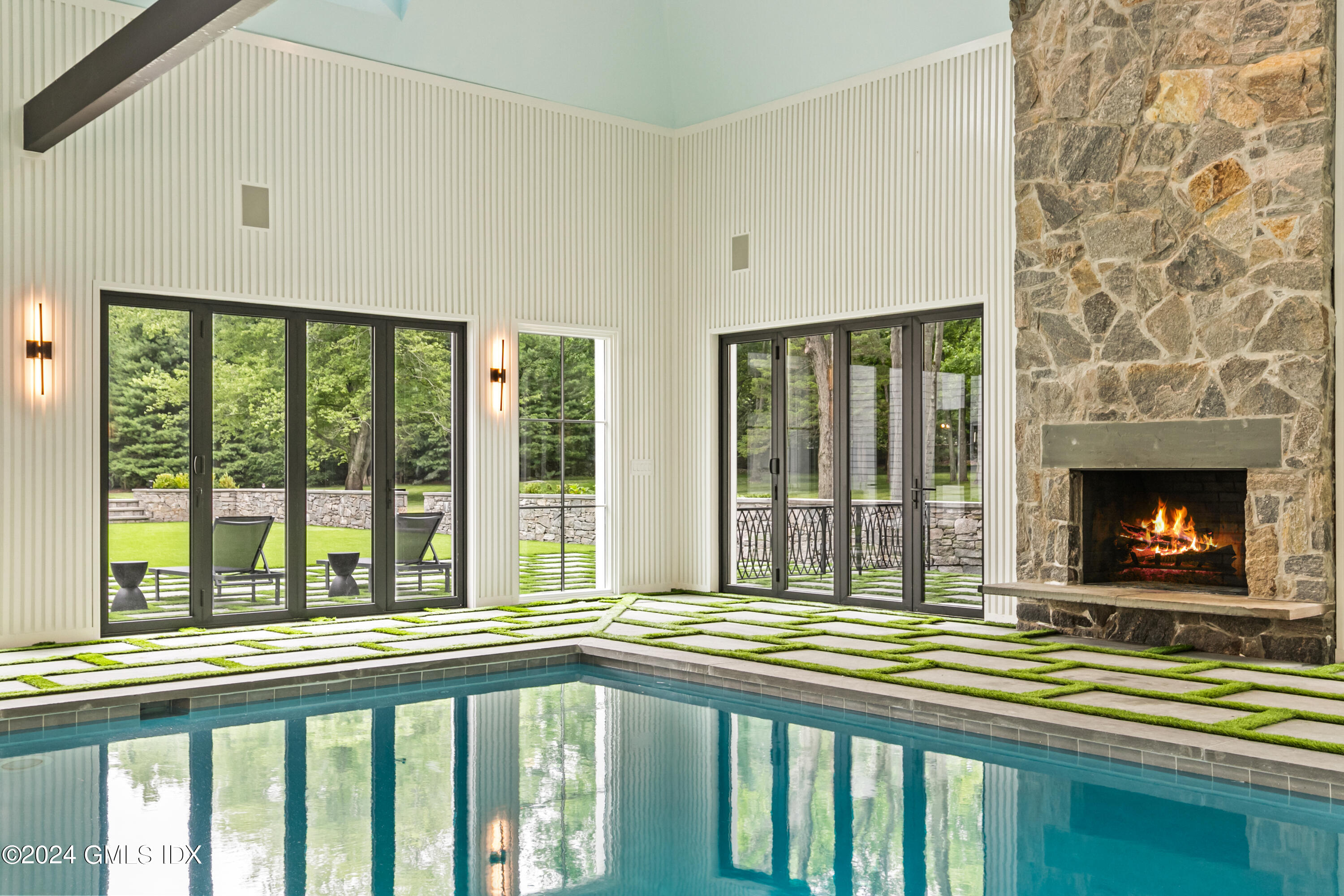 248 Round Hill Road Greenwich, CT 06831 - Photo 35 of 49 a view of a porch with a floor to ceiling window and a fireplace