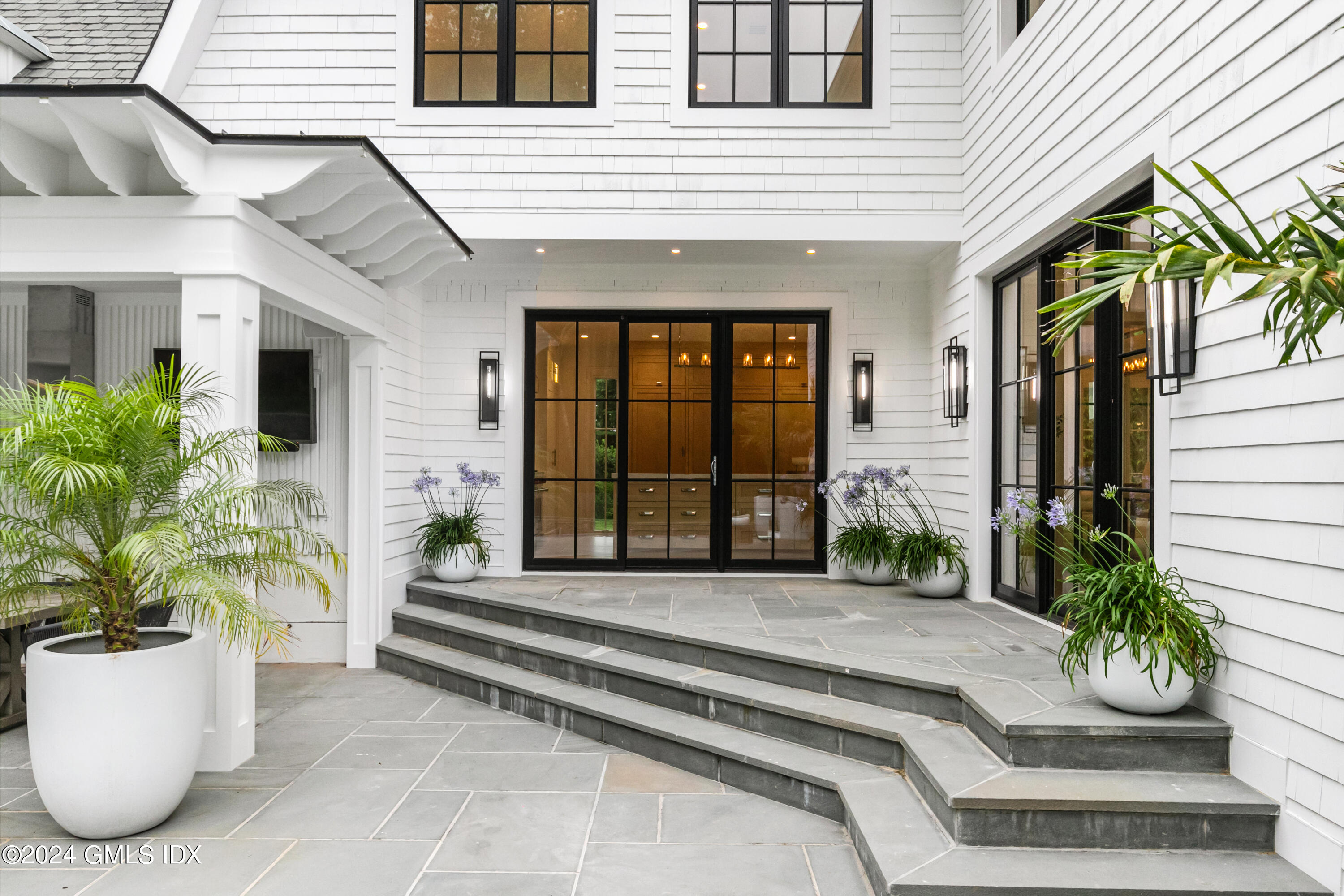 248 Round Hill Road Greenwich, CT 06831 - Photo 37 of 49 a front view of a house with a garden