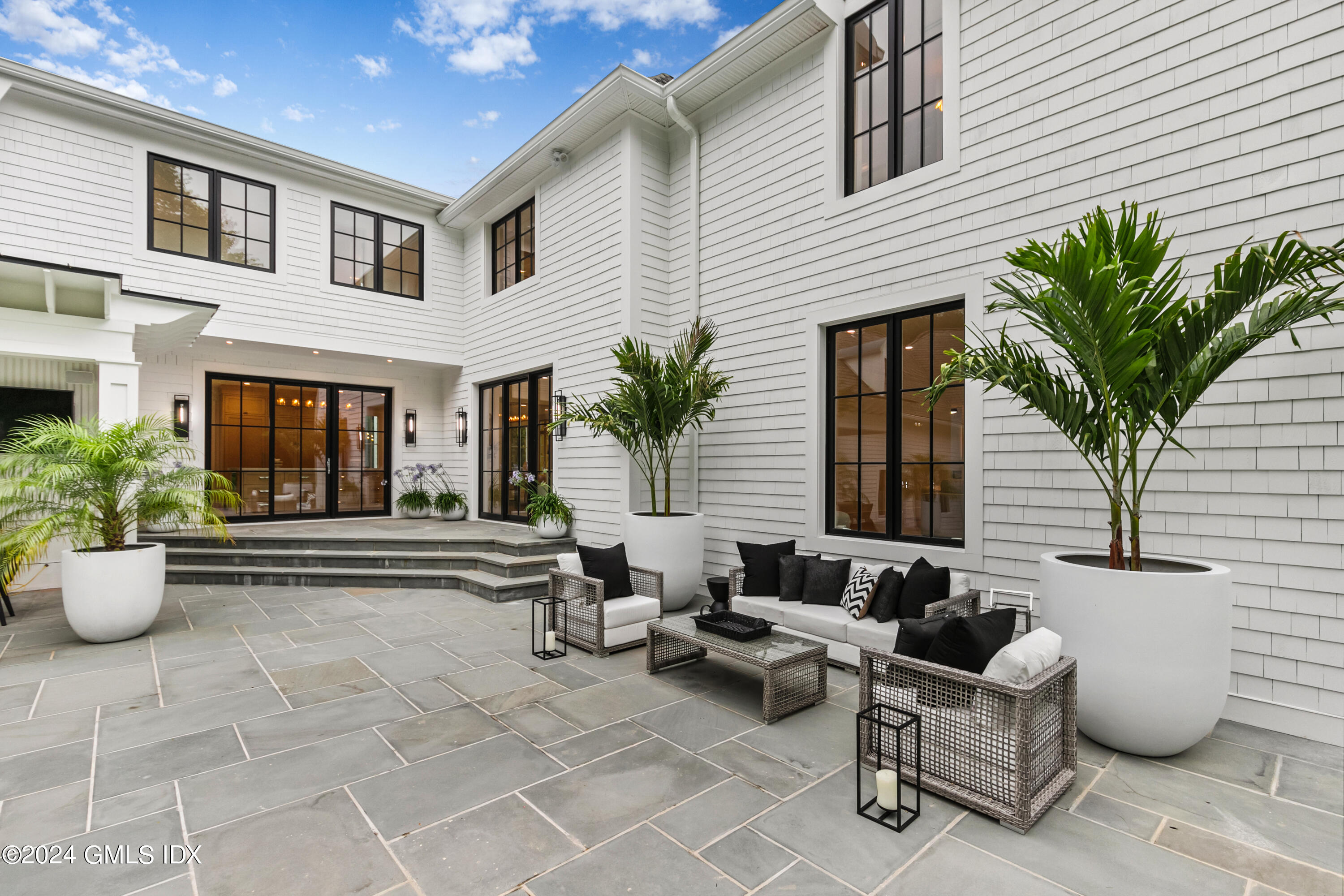 248 Round Hill Road Greenwich, CT 06831 - Photo 38 of 49 a view of a patio with couches and potted plants