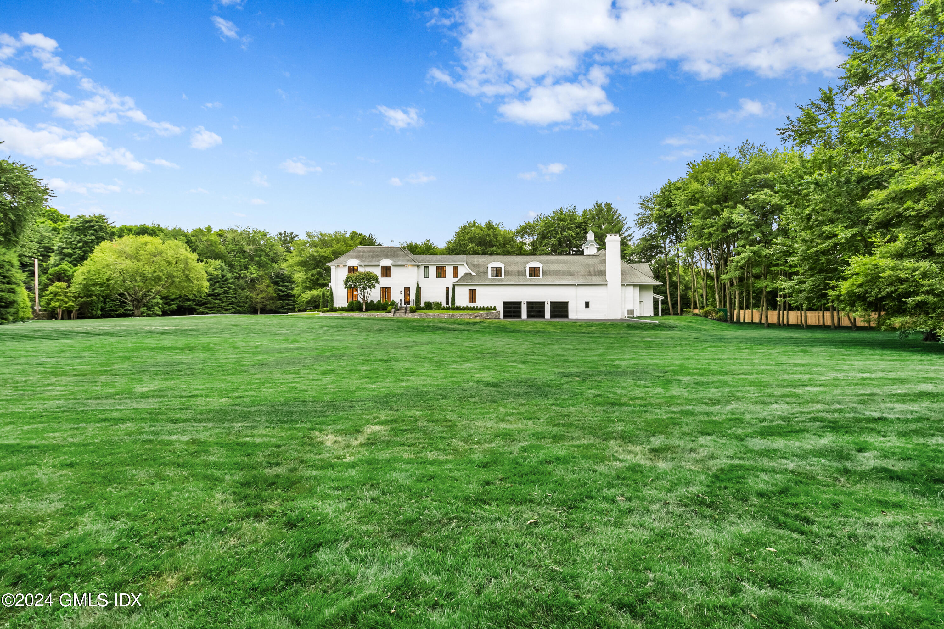 248 Round Hill Road Greenwich, CT 06831 - Photo 42 of 49 a view of a big yard with plants and large trees