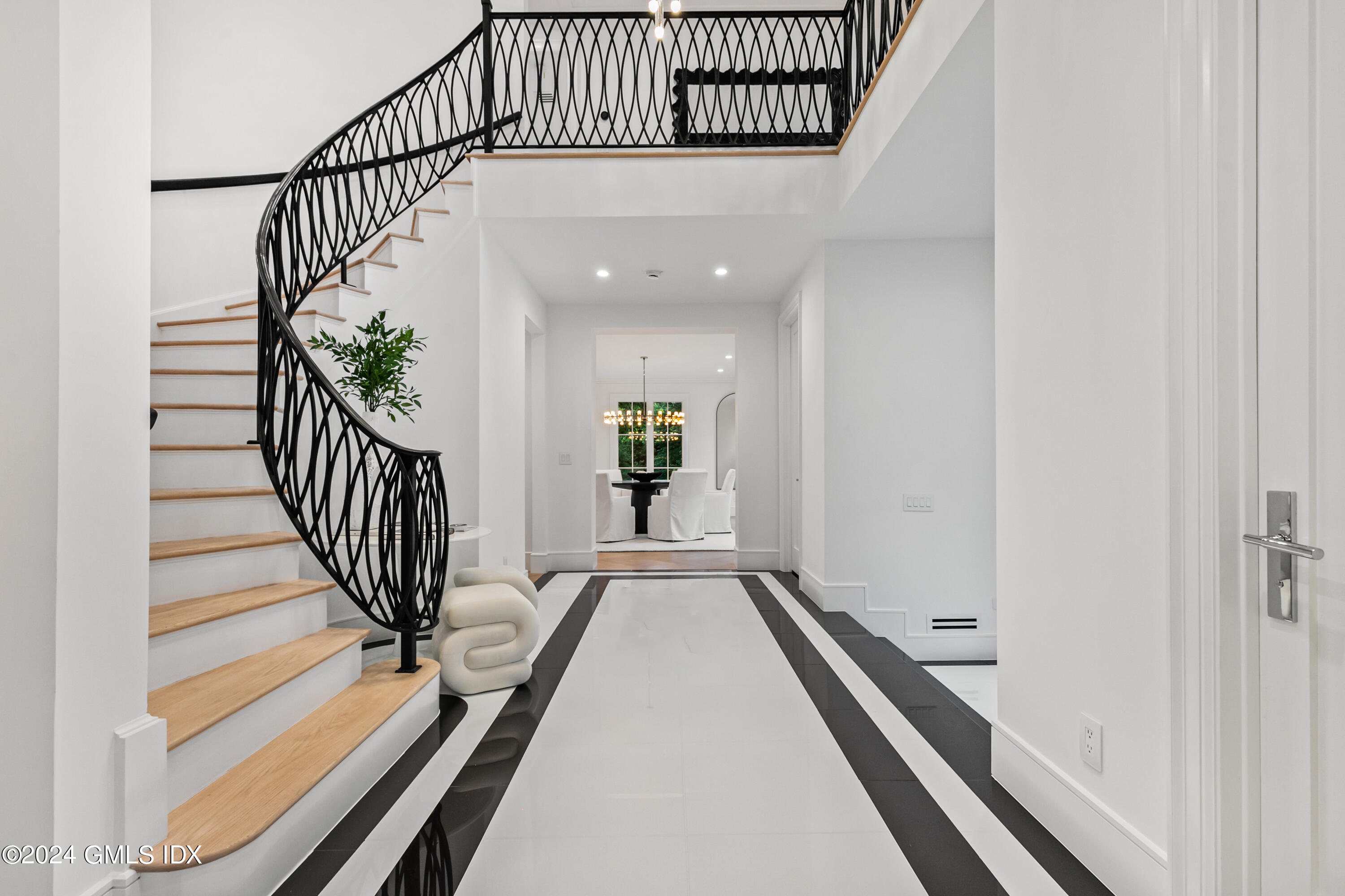 248 Round Hill Road Greenwich, CT 06831 - Photo 6 of 49 a view of a hallway with wooden floor and staircase