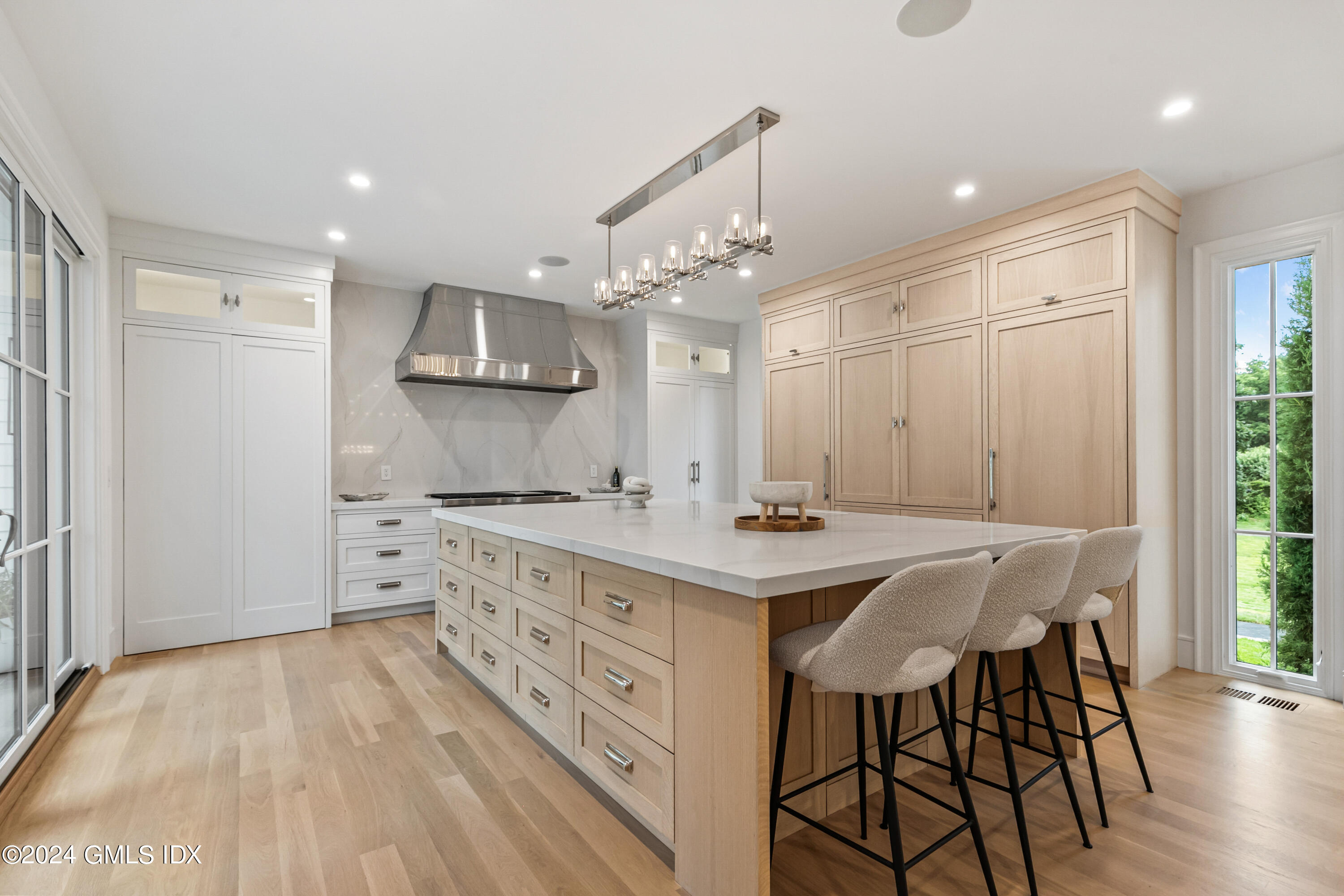 248 Round Hill Road Greenwich, CT 06831 - Photo 10 of 49 a kitchen with stainless steel appliances a table and chairs in it