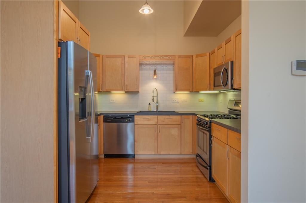 10 Walnut Street, Unit 6 Pittsburgh, PA 15202 - Photo 16 of 35 a kitchen with stainless steel appliances granite countertop a stove a sink and a refrigerator