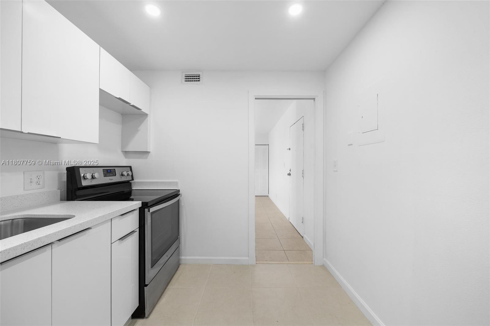 4222 Inverrary Boulevard, Unit 4211 Lauderhill, FL 33319 - Photo 2 of 17 a kitchen with a sink and white cabinets