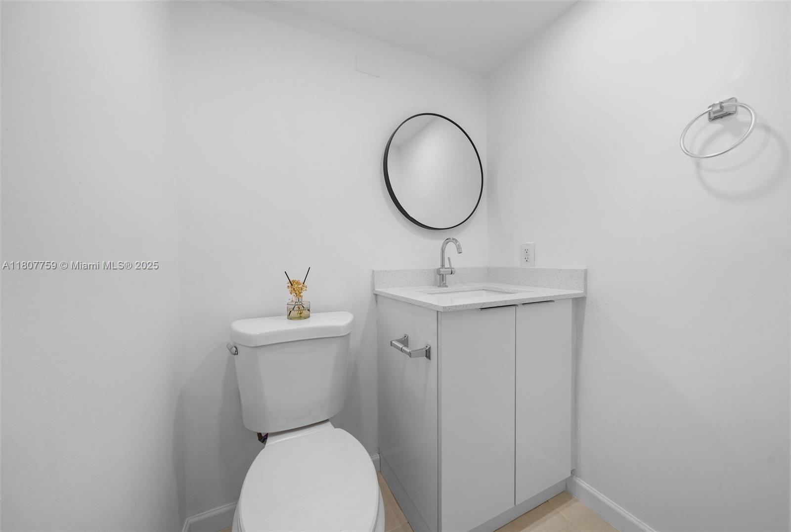4222 Inverrary Boulevard, Unit 4211 Lauderhill, FL 33319 - Photo 5 of 17 a bathroom with a toilet a sink and a mirror