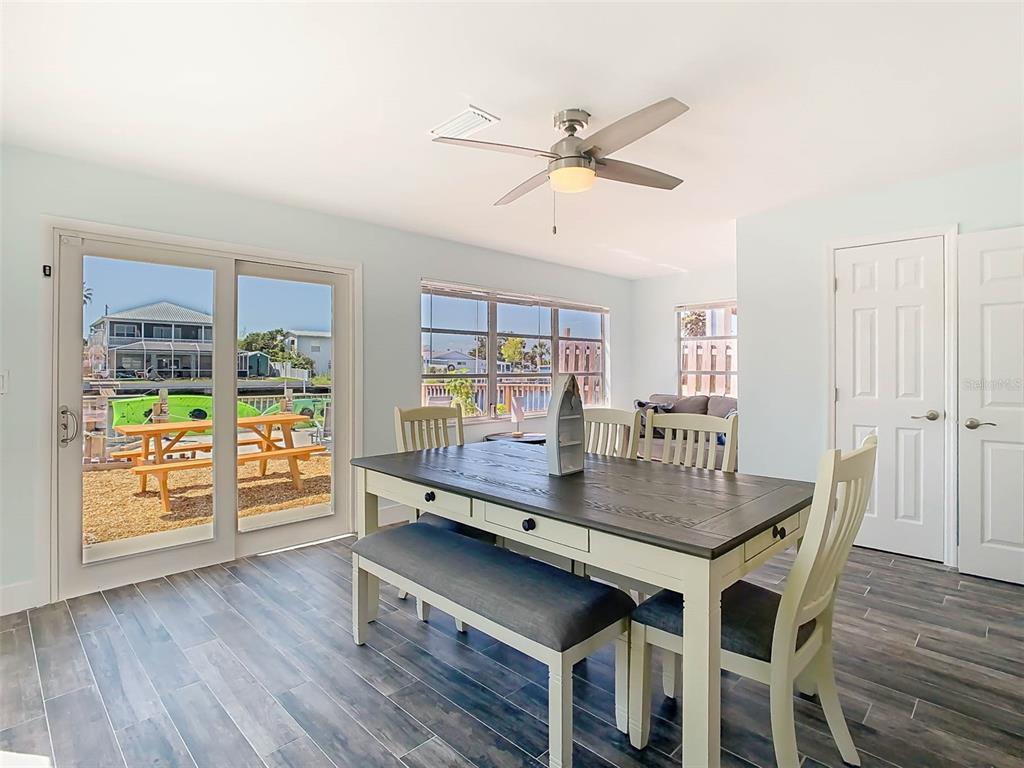 4984 Cedarbrook Lane Hernando Beach, FL 34607 - Photo 24 of 65 a dining room with furniture and wooden floor