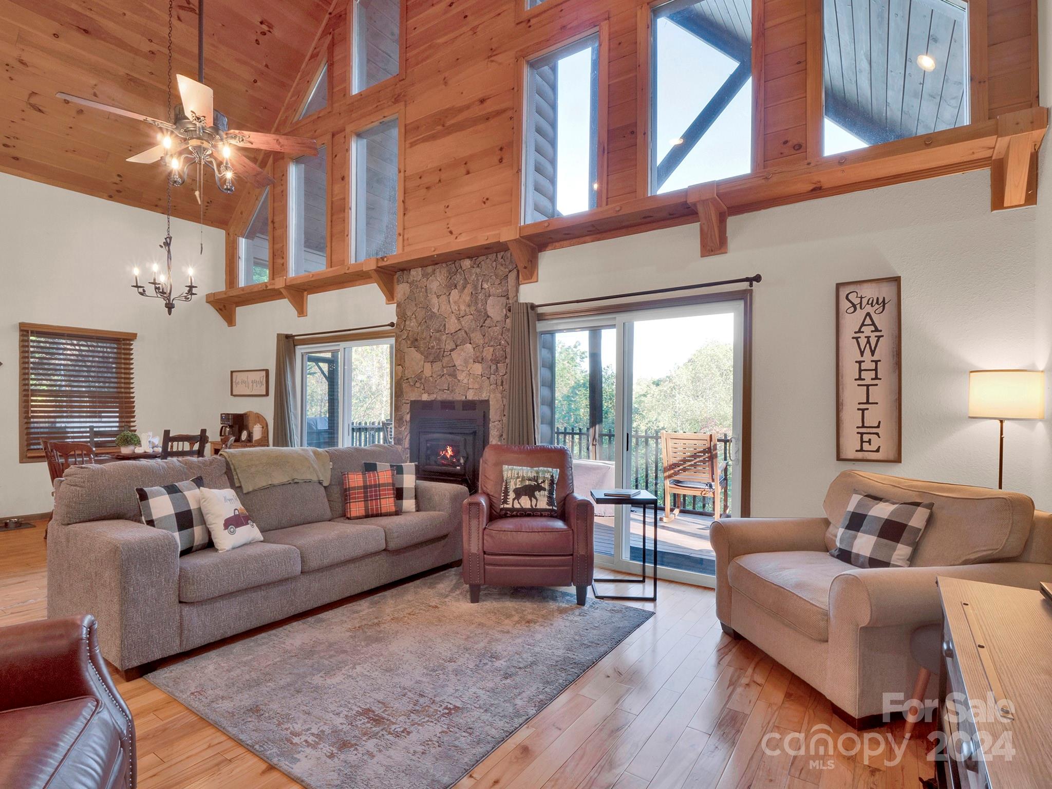 a living room with furniture a fireplace and a rug