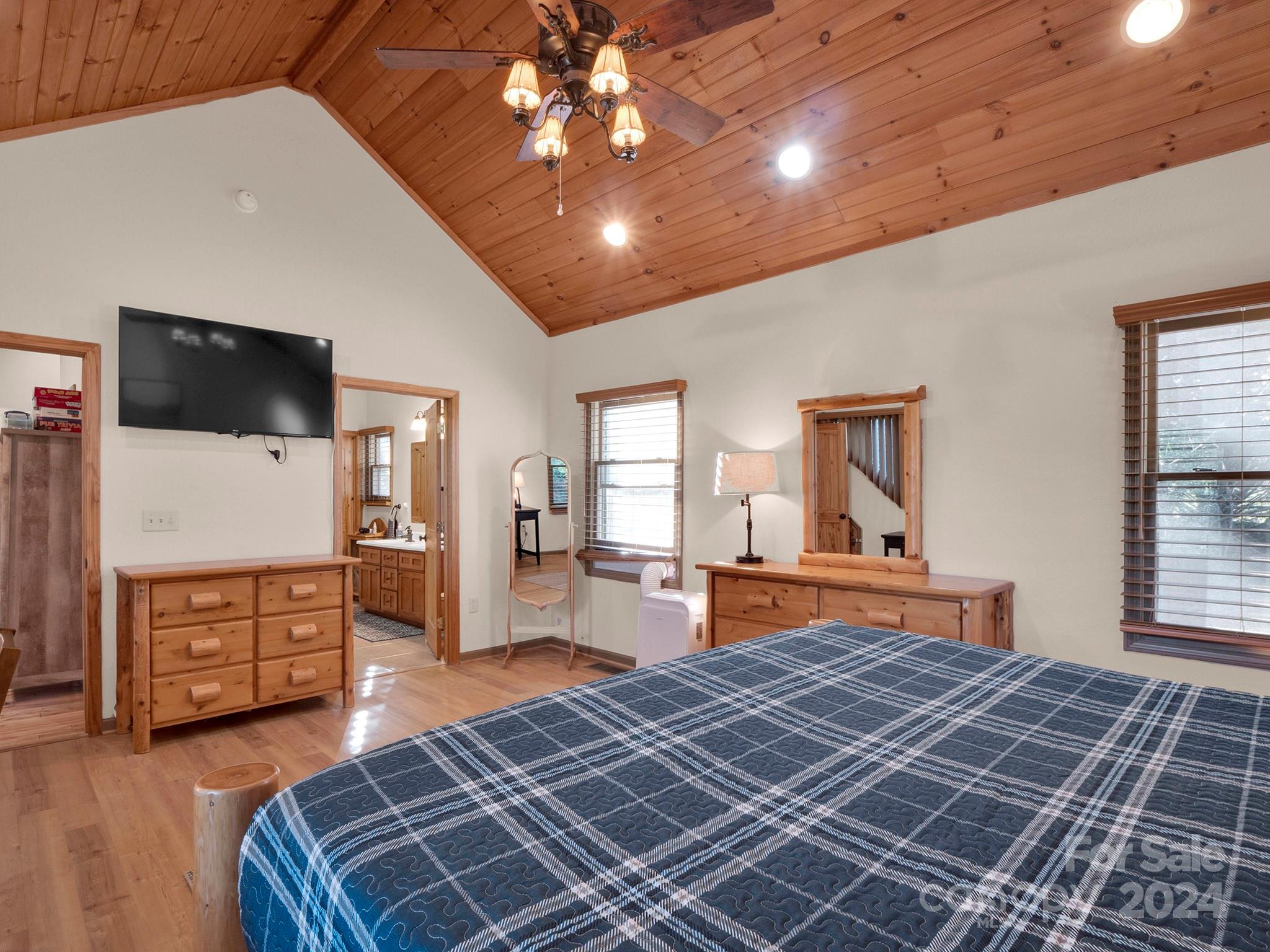 195 Grandview Mesa Road Whittier, NC 28789 - Photo 20 of 37 a bedroom with furniture and a flat screen tv