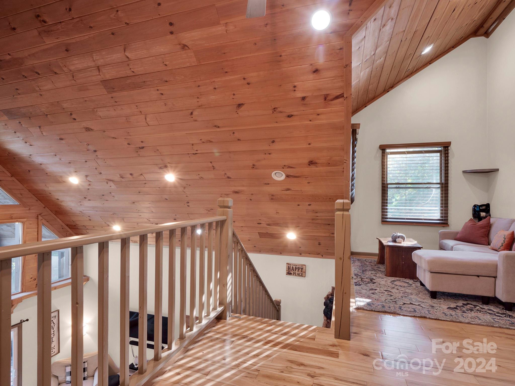 195 Grandview Mesa Road Whittier, NC 28789 - Photo 25 of 37 a spacious bedroom with a bed and wooden floor