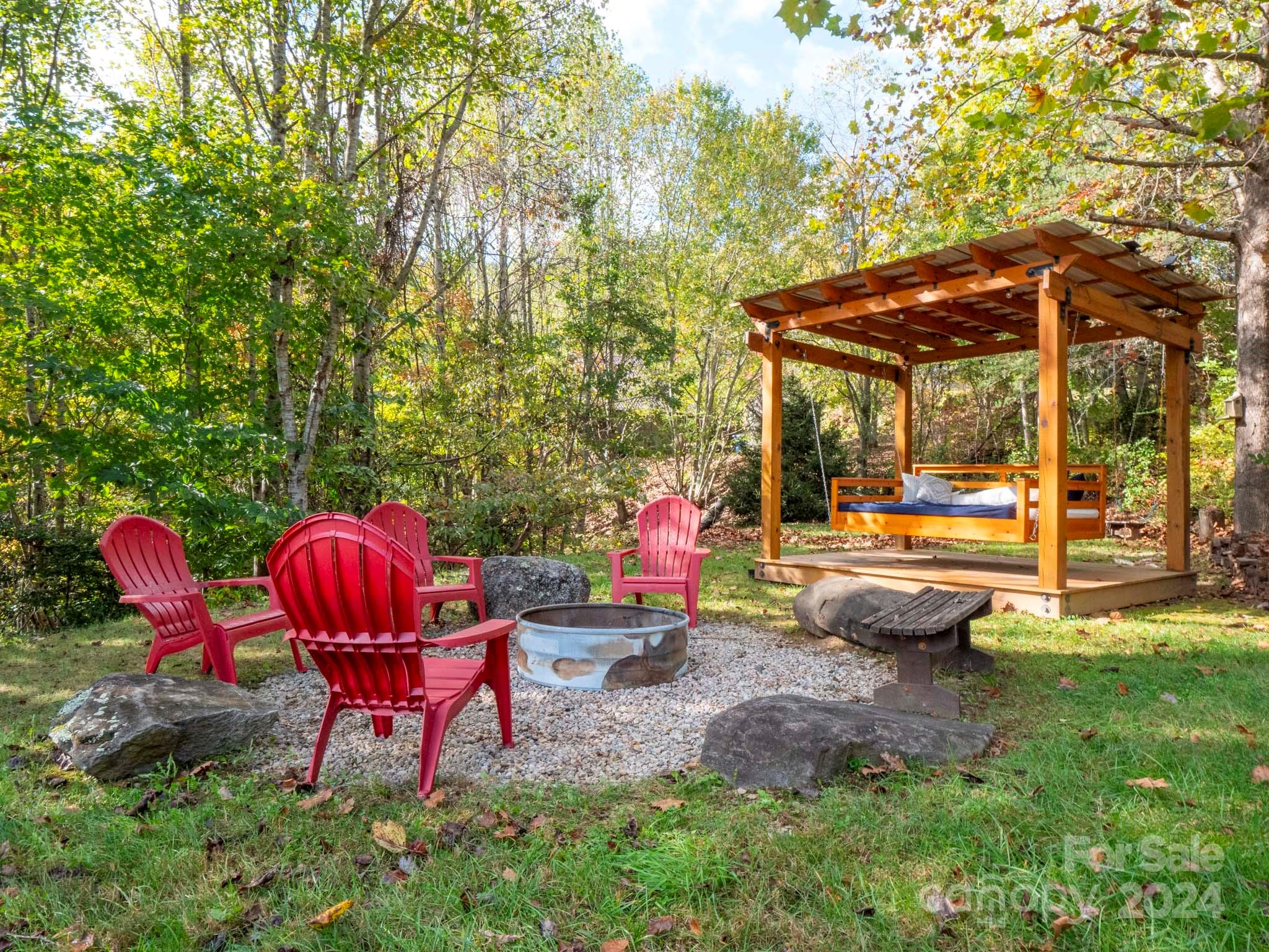 195 Grandview Mesa Road Whittier, NC 28789 - Photo 34 of 37 a backyard of a house with table and chairs