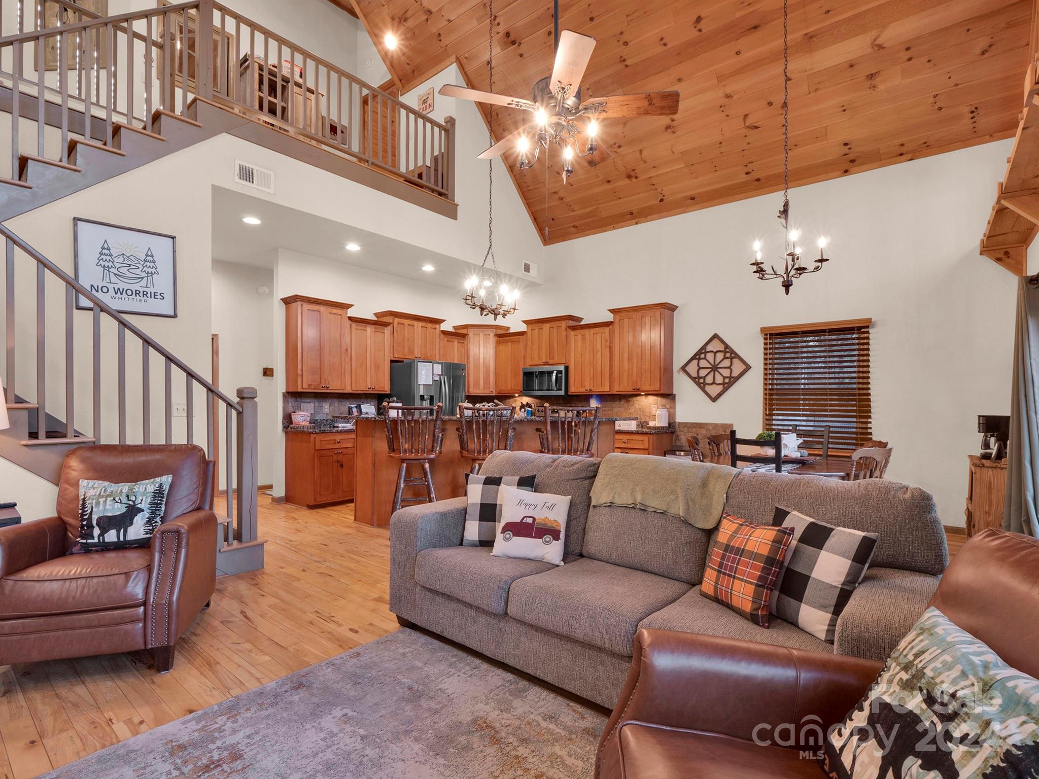 195 Grandview Mesa Road Whittier, NC 28789 - Photo 5 of 37 a living room with furniture kitchen view and a chandelier