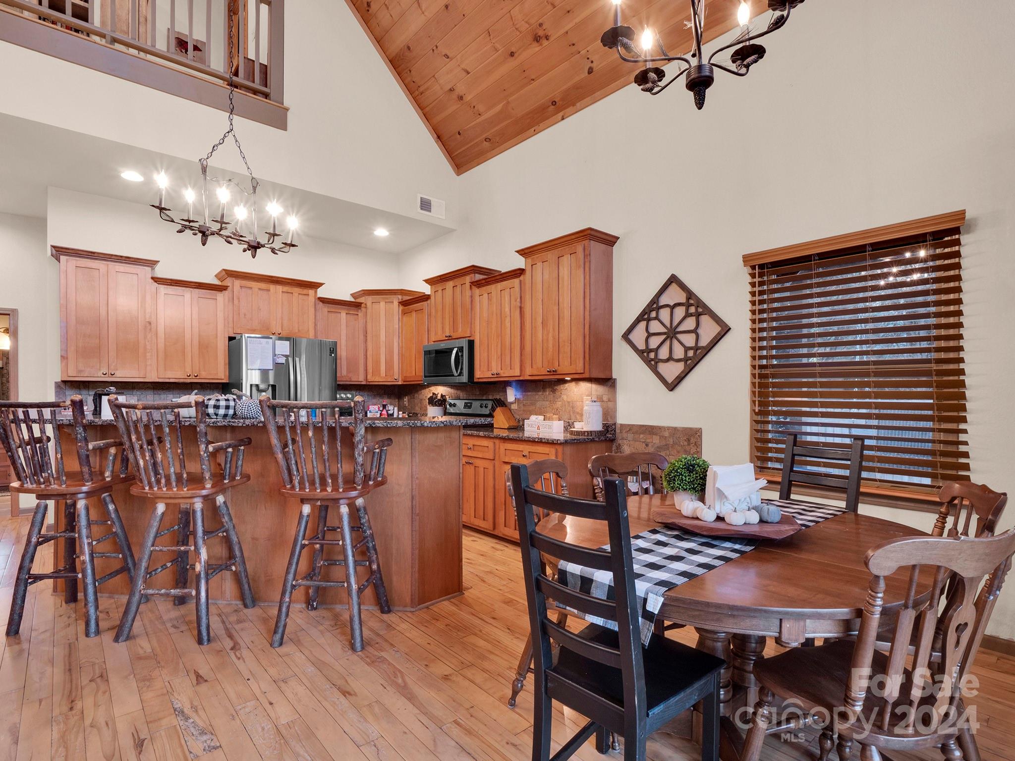 195 Grandview Mesa Road Whittier, NC 28789 - Photo 8 of 37 a view of a dining room with furniture and wooden floor