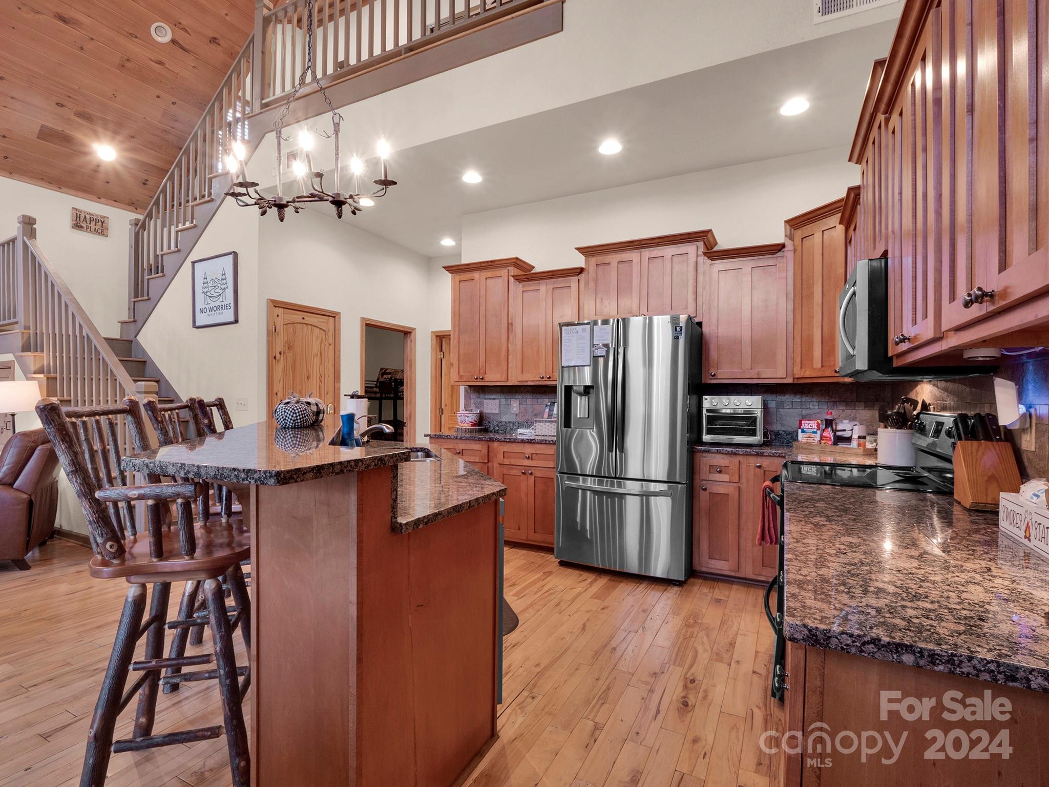 195 Grandview Mesa Road Whittier, NC 28789 - Photo 9 of 37 a kitchen with refrigerator and chairs