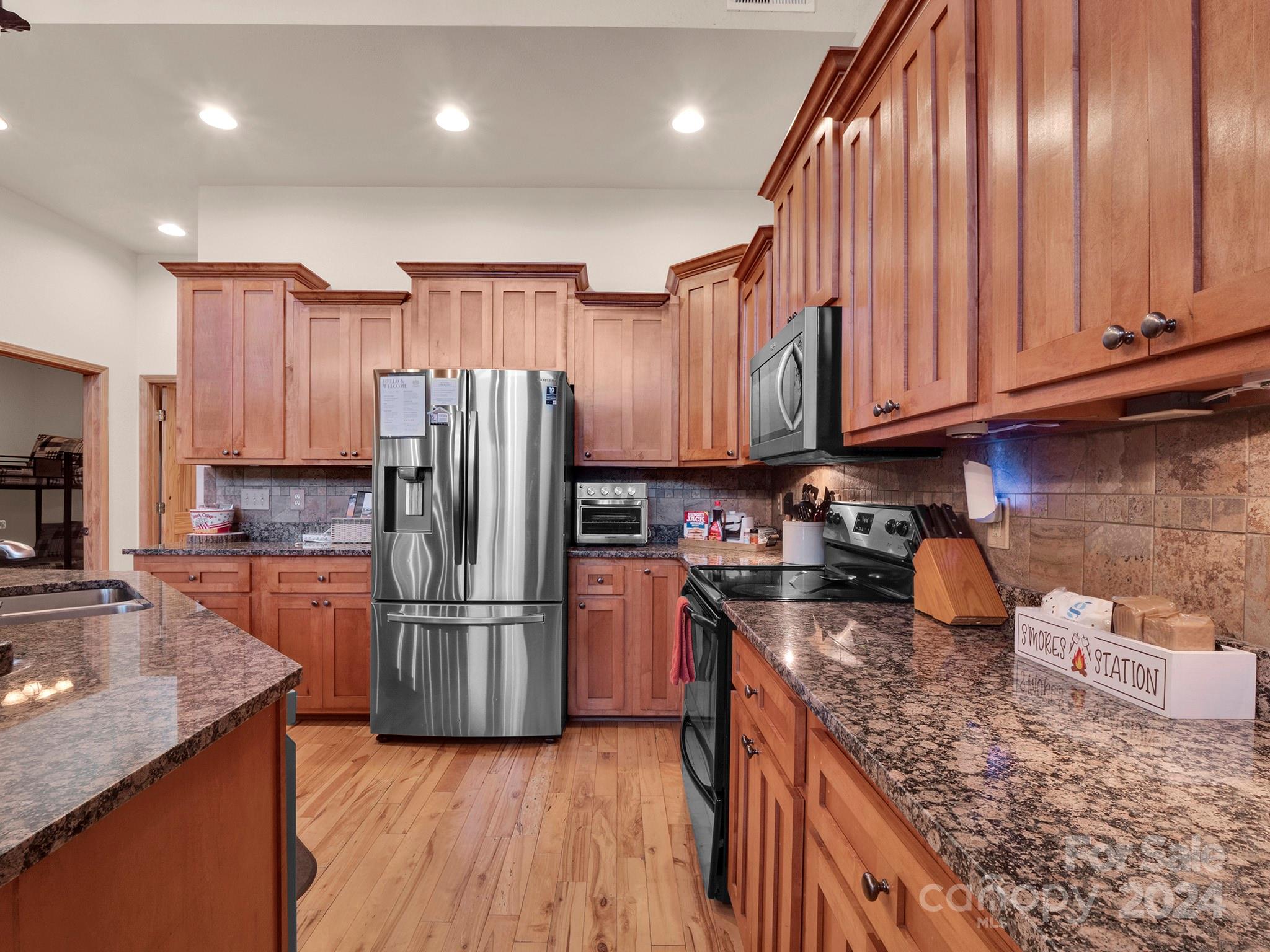 195 Grandview Mesa Road Whittier, NC 28789 - Photo 10 of 37 a kitchen with granite countertop stainless steel appliances a refrigerator and a sink